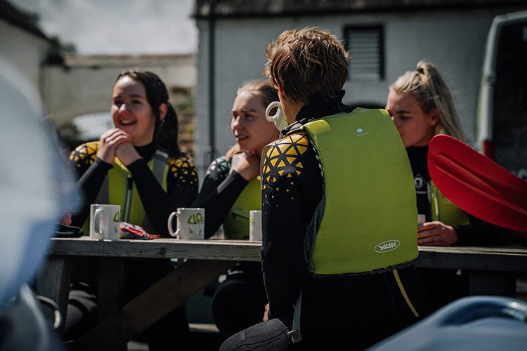 Two mountain bikers enjoying hot drinks and traybake in Synge & Burn at the end of the Rostrevor Red MTB trail